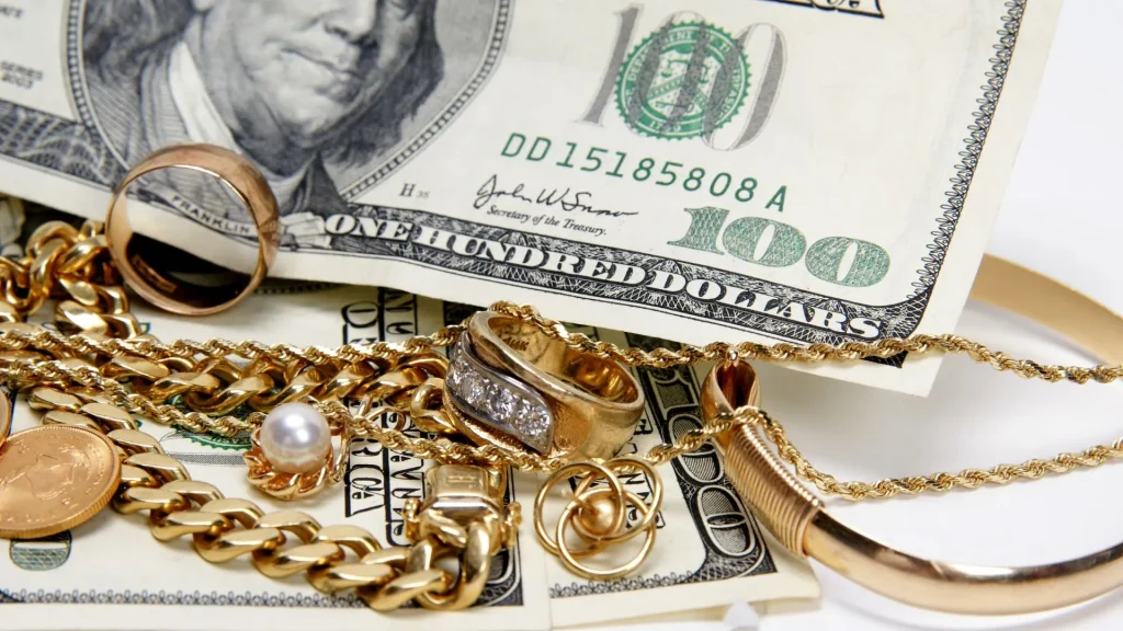 Gold jewelry and US currency arranged for jewelry documents and valuation