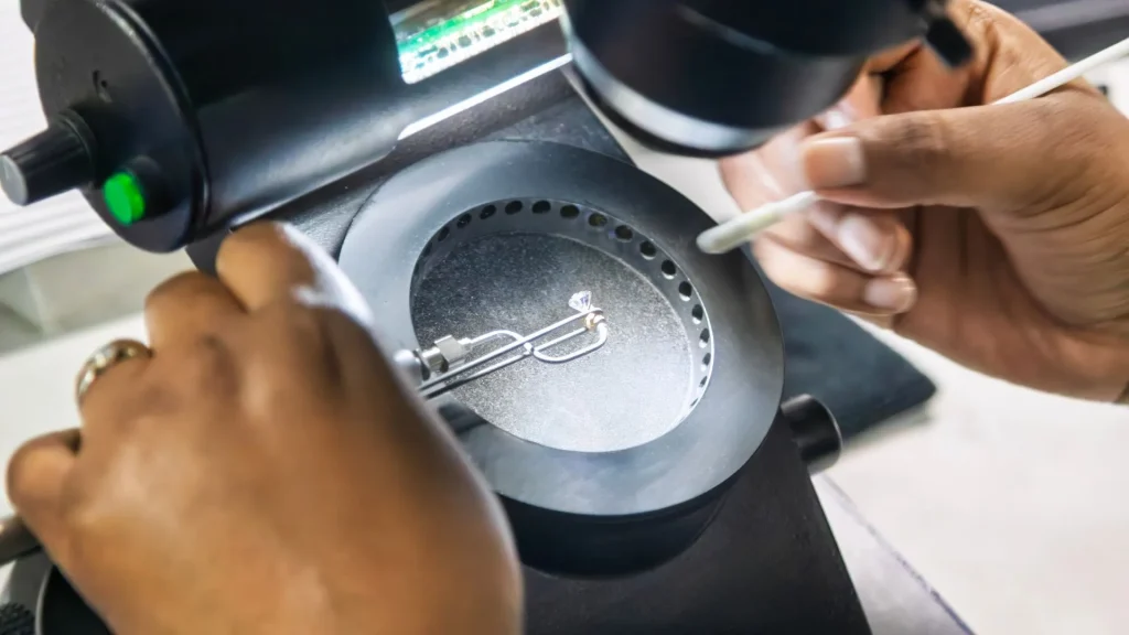 Diamond being inspected under a microscope for a Diamond Grading Report